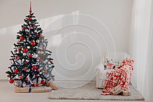 Christmas tree in a white room for Christmas with gifts