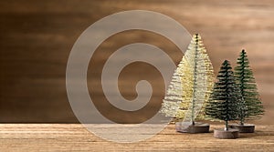 Christmas tree on wood table with wooden wall for merry chirstmas and new year holiday greeting card backgrond. banner mock up
