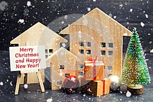 Christmas tree, wooden houses and gifts with the inscription