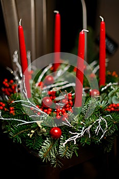 Christmas tree wreath decorated with four red candles isolated