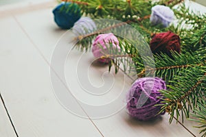 Christmas tree and yarn balls as decorations on wooden background