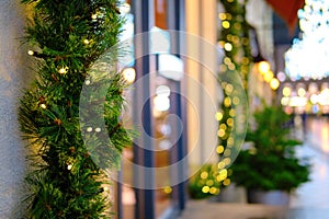 Christmas trees are decorated with garlands at the shop window on new year eve
