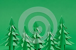 Christmas trees paper artwork in green background. Christmas tree paper cutting