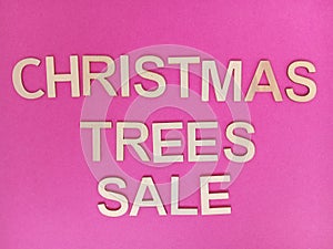 Christmas trees sale message on a pink background