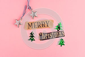 Christmas trees, toy stars, snowflake and Merry Christmas lettering inscription on a pink background. Winter Holiday festive