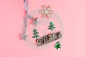 Christmas trees, toy stars, snowflake and Winter lettering inscription on a pink background. Winter Holiday festive greeting gift