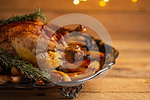 The Christmas turkey with baked potatoes on the holiday dish. Festive dinner for Christmas. Close-up, horizontal photo.