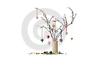 Christmas twig tree decoration. Bells and baubles. White background.