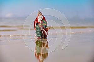 Christmas vacation background. Santa Claus on sea beach. Happy New Year and merry Christmas travel, tropical vacations