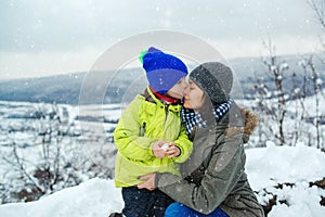 Christmas vacation. Happy family and childhood. Mother and child on snowy winter walk