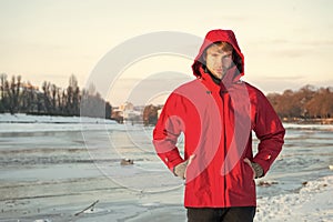 Christmas vacation. human and nature. man walking snowy landscape in sunset. travel and expedition concept. man in red