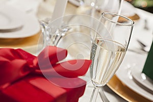 Christmas or Valentine Gift on Place Setting at Elegant Table