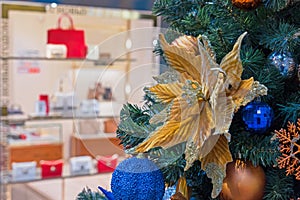 Christmas velvet flower on Christmas tree. Velvet poinsettia with glitter. New Year concept