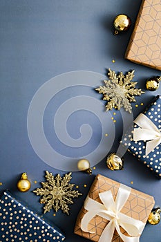 Christmas vertical blue background, xmas poster, social media stories banner design. Flat lay Christmas gift boxes and golden