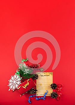 Christmas vertical composition, still life on a red background, top view with ribbons, gifts, snowflakes, copy space