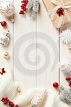 Christmas vertical wooden background with Xmas decorations, gift box, fir branches. Flat lay, top view, copy space