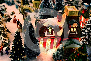 Christmas Village detail with lit building and snow - selective focus