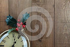 Christmas vintage pocket watch, berries, holly, wood. Copy space