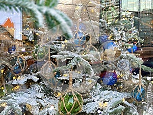 Christmas  vitrines trees decoration reflection on street vitrines snowflakes and gold confeti on glass  at holiday urban st photo