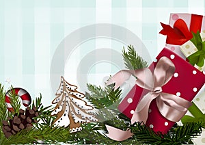 Christmas wallpaper made of fir branches, festive decorations, gift boxes and pine cones on table. Christmas background.top view
