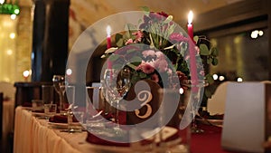 Christmas wedding banquet hall interior details with decorand table setting at restaurant. Winter season decoration of