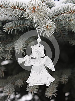 Christmas white angel with snowflakes on christmas tree