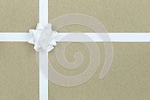 Christmas White Bow and ribbon on brown paper background