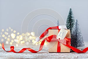 Christmas white box or present with red ribbon from Secret Danta with santa hat and xmas trees. Happy holiday concept