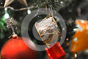 Christmas white silver drum hanging on a beautiful Chrismas tree surrounded by red shinning ball