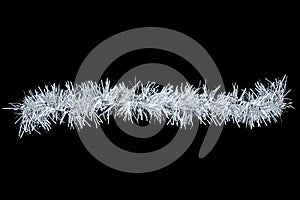 Christmas white tinsel on black background. View from above