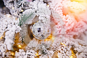 Christmas white tree decorated snow illumination and gifts toys, background sun light bokeh