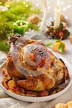 Christmas whole roast chicken with tangerines, apples and thyme