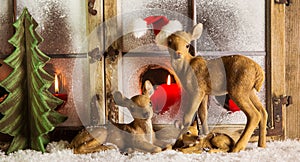 Christmas window decoration: deer family with red candles.