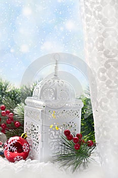Christmas window decoration with white lantern and fir