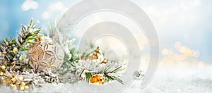 Christmas winter background with Christmas baubles and fir tree branches on snow
