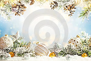 Christmas winter background with Christmas baubles and fir tree branches on snow