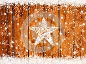 Christmas winter background with snowflakes on wooden board and star from snow