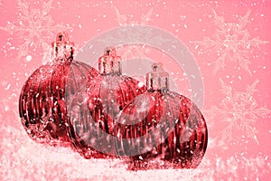 Christmas. Winter background .Wallpaper, postcard. Snow, balls, snowflakes on a pink background