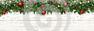 Christmas winter banner with snow and snowflake on white wooden background fir tree branches and new year toy ball or bauble.