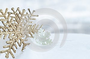 Christmas of  winter - Christmas Snowflakes on snow, Winter holidays concept. White and Golden Snowflakes decorations In Snow Back