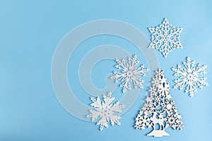 Christmas or winter composition. Pattern made of white elements on pastel blue background. Christmas, winter, new year concept.