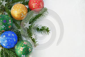 Christmas winter decorations. Christmas border with green spruce branches with silver stars and multi-colored handmade balls