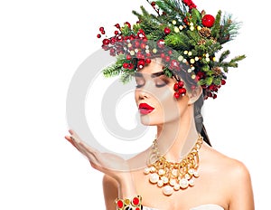 Christmas winter fashion girl blowing with magic snow in her hand over white