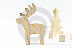 Christmas winter festive ornament. Wooden reindeer, pine tree and gift boxes decoration on white background. Christmas holiday