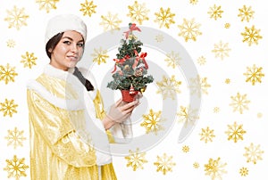 Christmas Winter woman with a magic Christmas tree. Snow maiden.