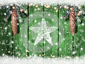 Christmas or winter wooden background with snowy fir branches and snow flakes