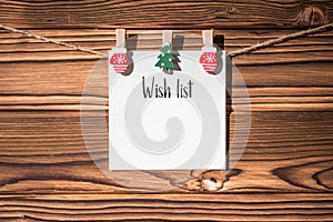 Christmas wish list to SAnta Claus on the paper sticker hanging on a rope on wooden clothespins. concept. Christmas and winter