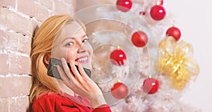 Christmas wishes concept. Woman pretty peaceful dreamy face hold smartphone enjoy mobile phone conversation. Girl near