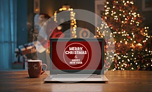 Christmas wishes on a laptop and Santa bringing gifts at home