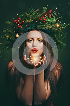 Christmas woman blowing magical dust